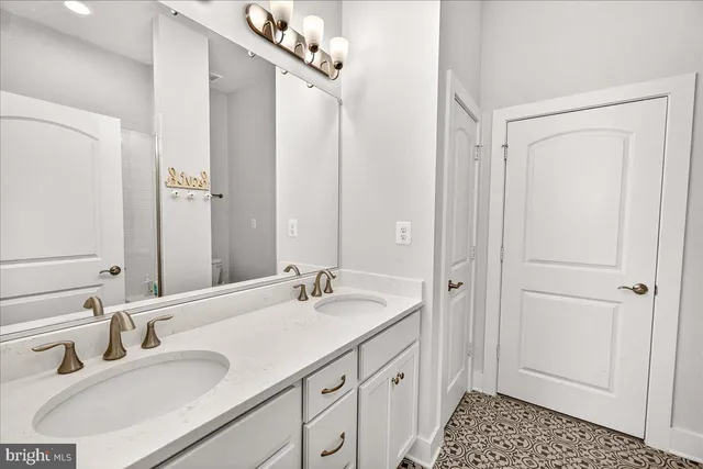 a bathroom with a sink double vanity and a mirror