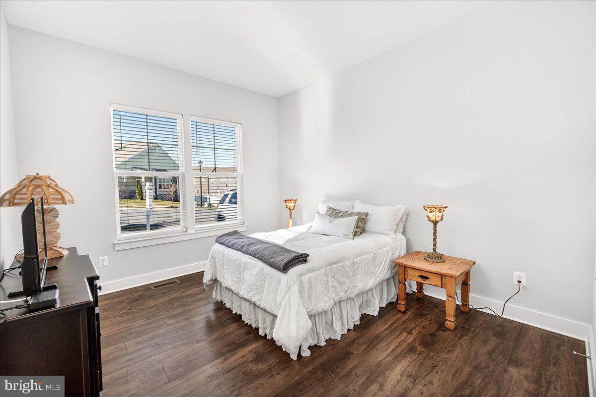 2896 Town View Circle New Windsor, MD 21776 - Photo 35 of 45 a bedroom with a bed and a flat tv screen on the dresser
