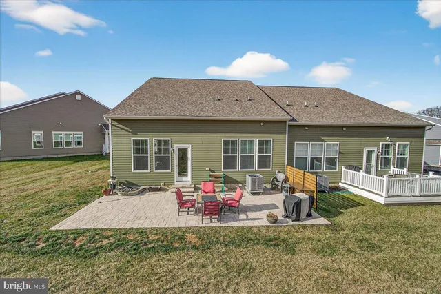 a front view of house with yard patio and fire pit