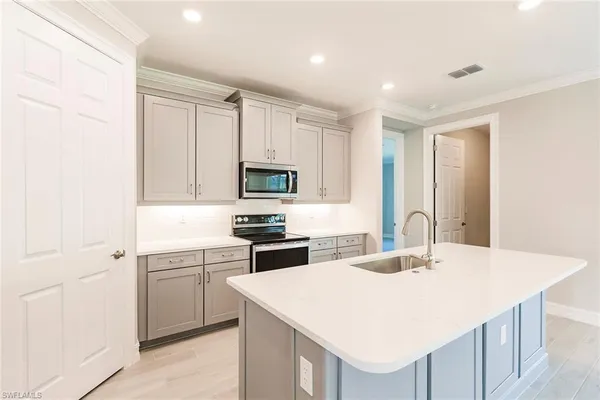 a kitchen with a stove a sink and a refrigerator