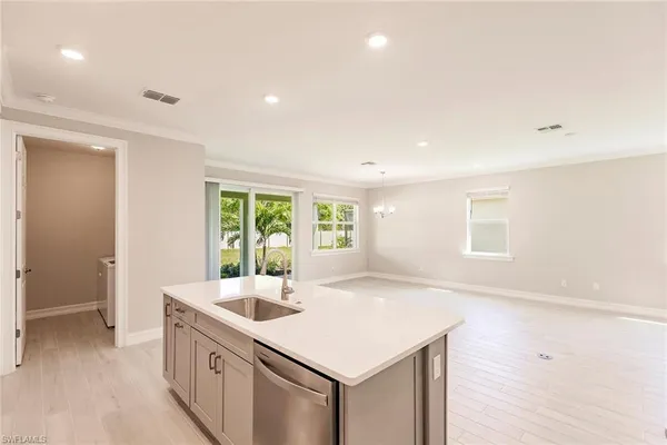a kitchen with a sink stove and microwave