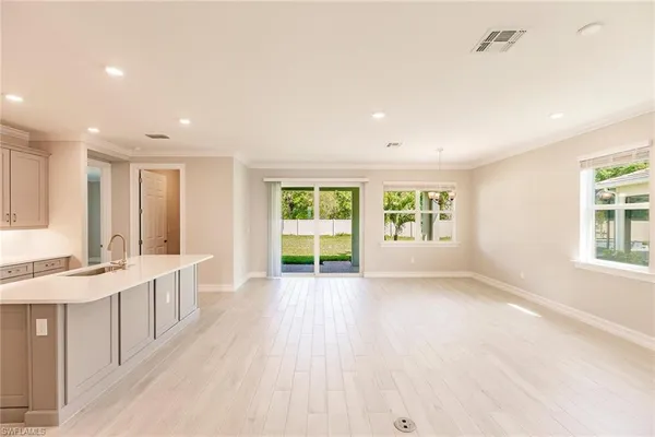 a large kitchen with a large window and stainless steel appliances