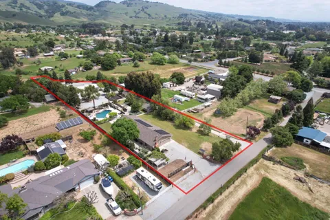 an aerial view of residential houses with outdoor space and river
