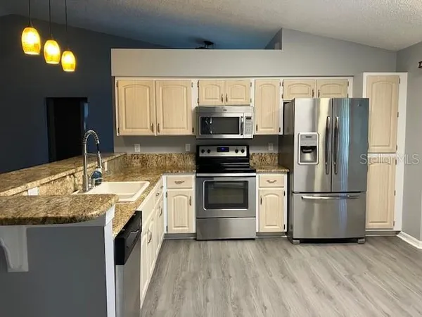 a kitchen with a sink and a refrigerator
