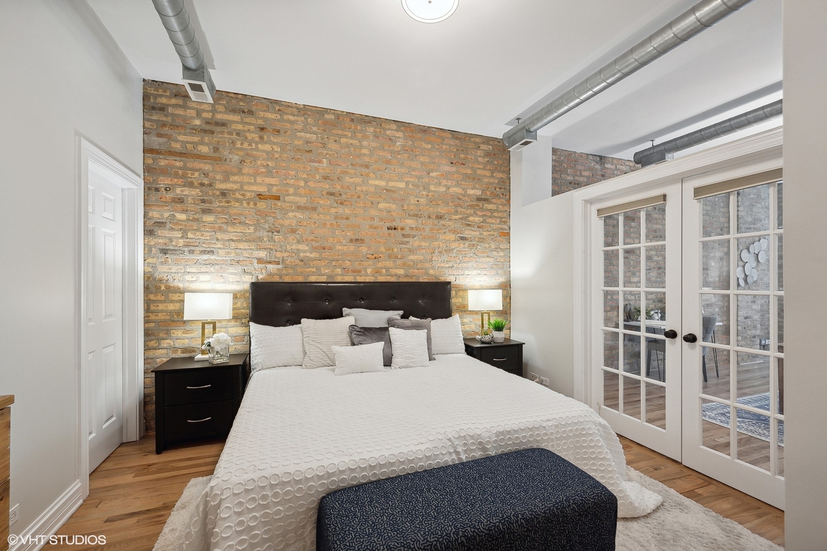 1245 West George Street, Unit 203 Chicago, IL 60657 - Photo 11 of 15 a bedroom with a balcony a bed and a table