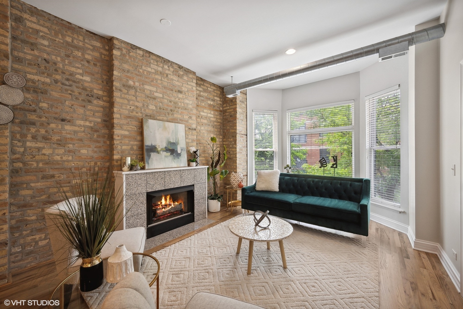 1245 West George Street, Unit 203 Chicago, IL 60657 - Photo 2 of 15 a living room with furniture and a fireplace