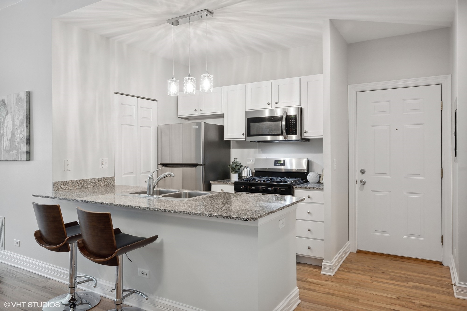1245 West George Street, Unit 203 Chicago, IL 60657 - Photo 4 of 15 a kitchen with stainless steel appliances a sink stove and refrigerator
