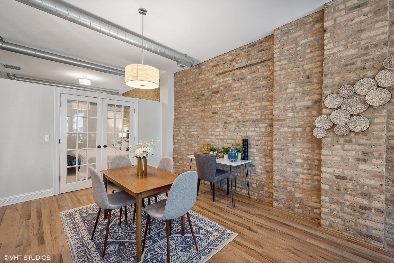 1245 West George Street, Unit 203 Chicago, IL 60657 - Photo 6 of 15 a dining room with furniture and wooden floor