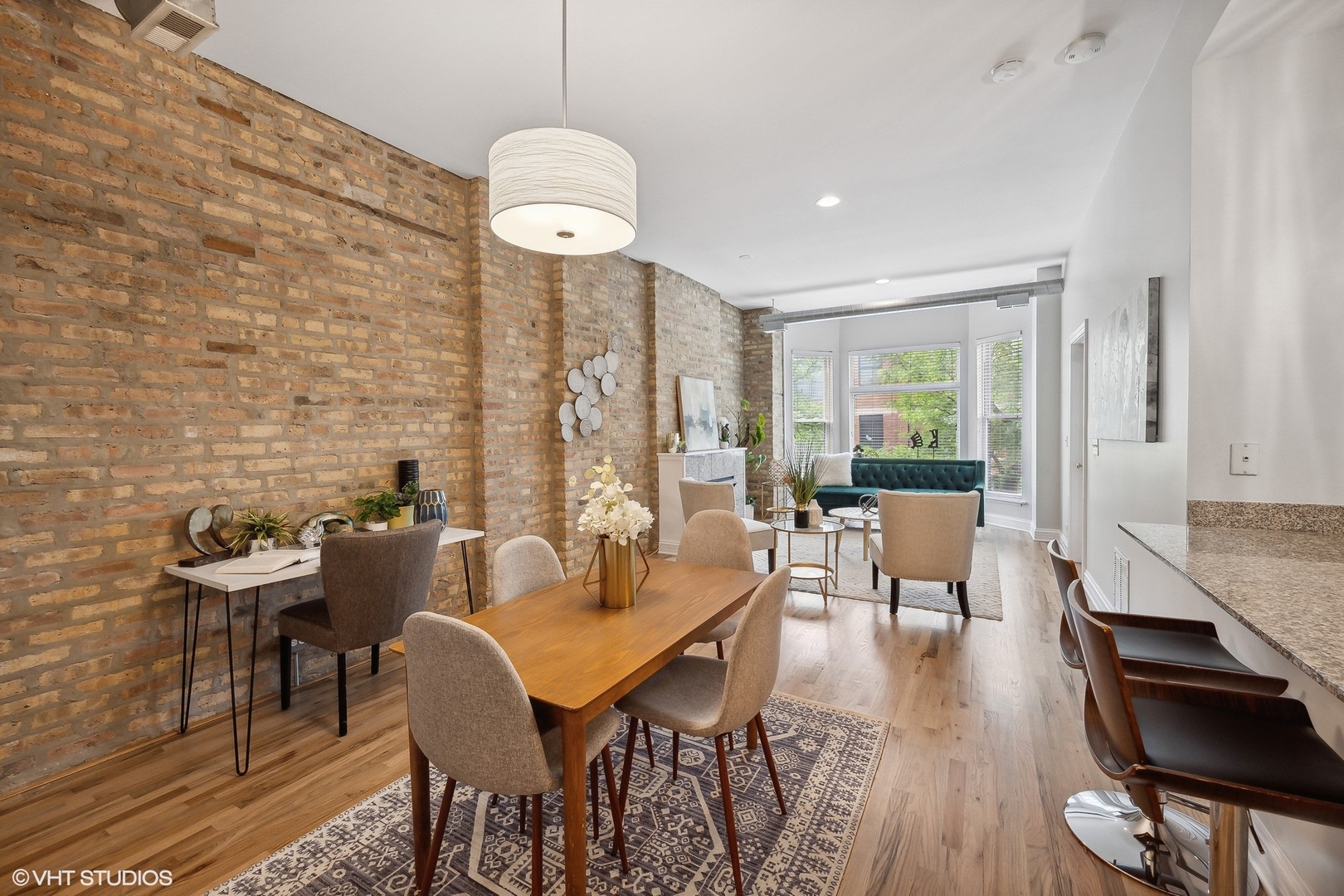 1245 West George Street, Unit 203 Chicago, IL 60657 - Photo 7 of 15 a dining room with furniture wooden floor and a chandelier