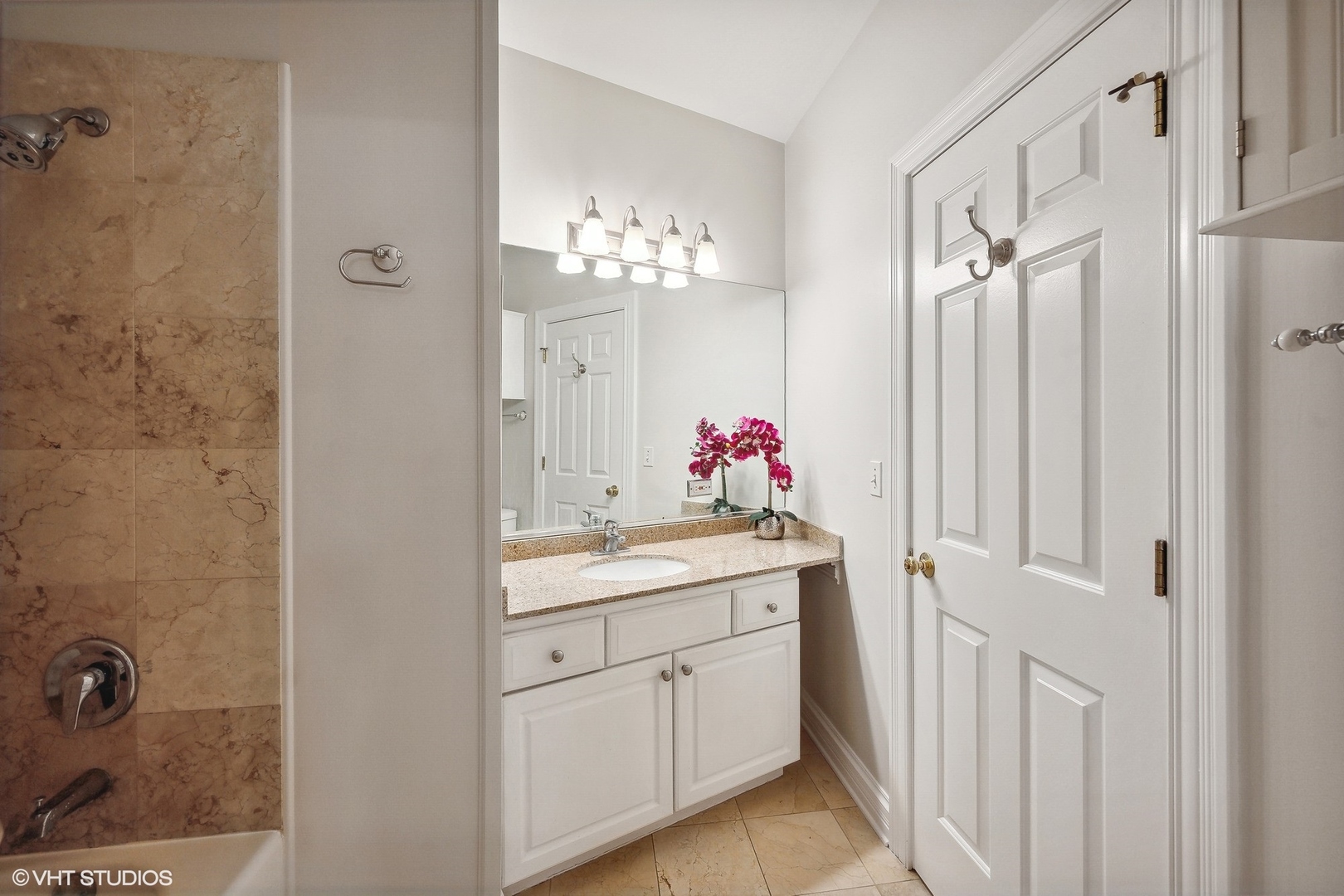 1245 West George Street, Unit 203 Chicago, IL 60657 - Photo 9 of 15 a bathroom with a shower sink vanity and mirror
