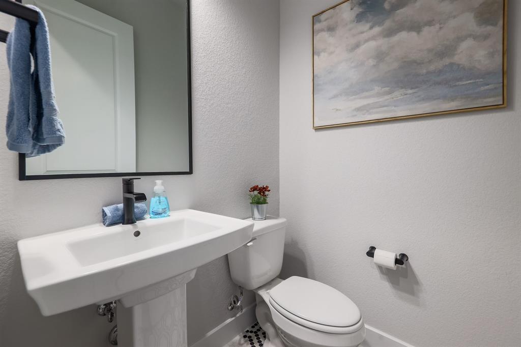 3907 Tilley Street Austin, TX 78723 - Photo 12 of 26 a bathroom with a sink mirror and toilet