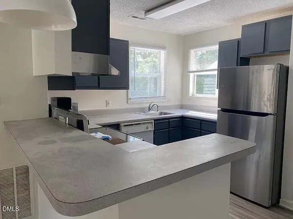 a kitchen with a sink cabinets and a stove top oven