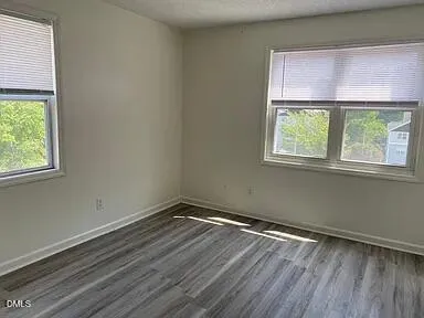 a kitchen with stainless steel appliances granite countertop a sink a stove a refrigerator and island with wooden floor