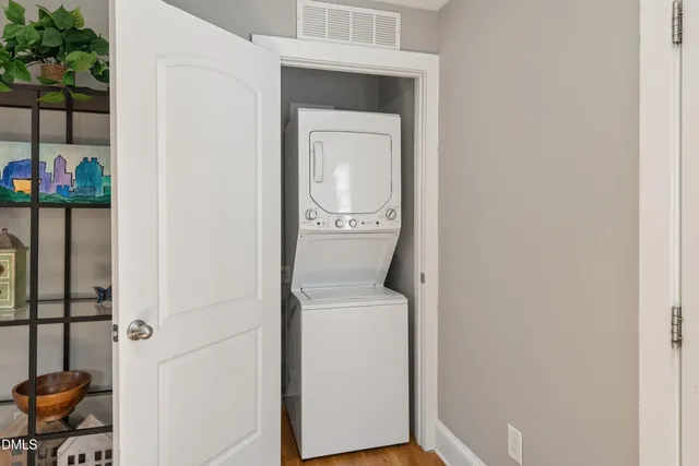 a view of a bedroom with wooden floor and a bedroom