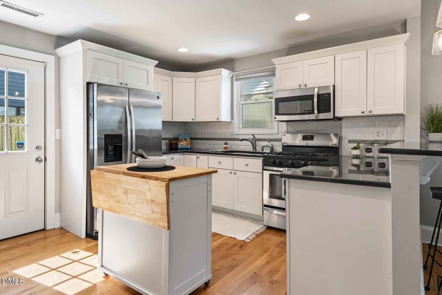 410 Bledsoe Avenue Raleigh, NC 27601 - Photo 14 of 37 a kitchen with stainless steel appliances granite countertop a refrigerator stove a sink and a microwave