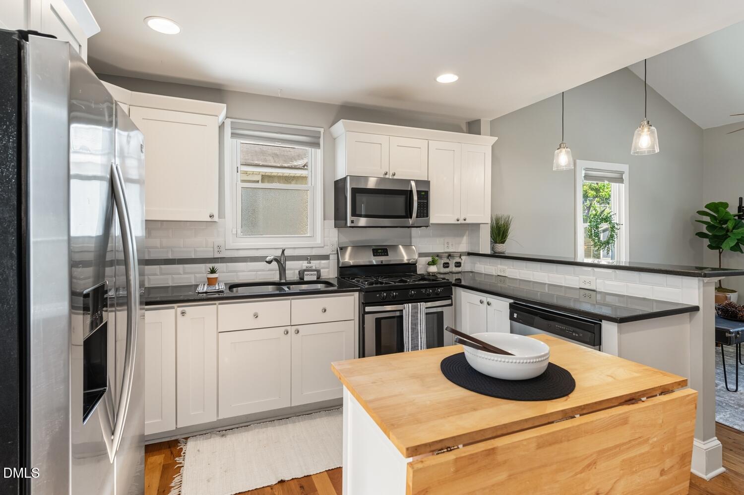 410 Bledsoe Avenue Raleigh, NC 27601 - Photo 4 of 37 a kitchen with a sink stove and refrigerator