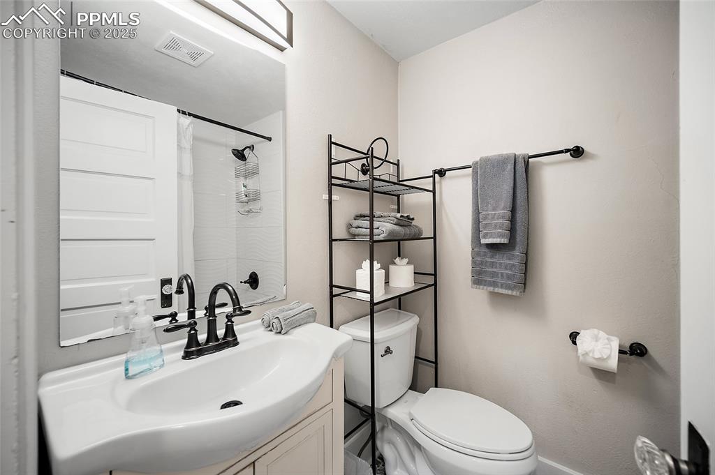 225 Custer Avenue Colorado Springs, CO 80903 - Photo 11 of 39 a bathroom with a sink toilet and shower