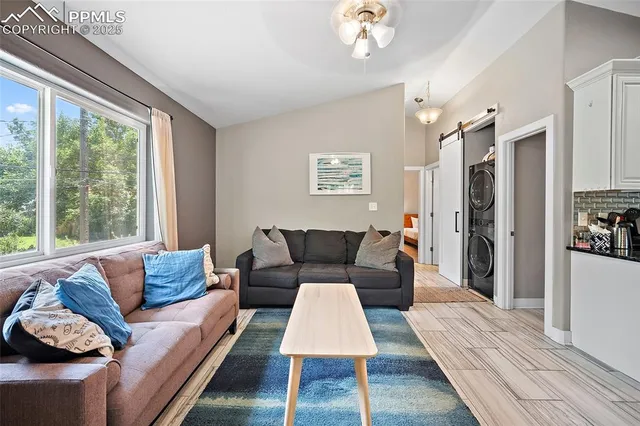 a living room with furniture and a large window