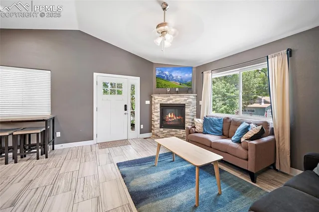 a living room with furniture and a fireplace