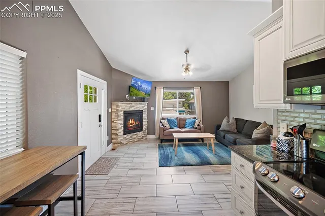 a living room with furniture and a fireplace