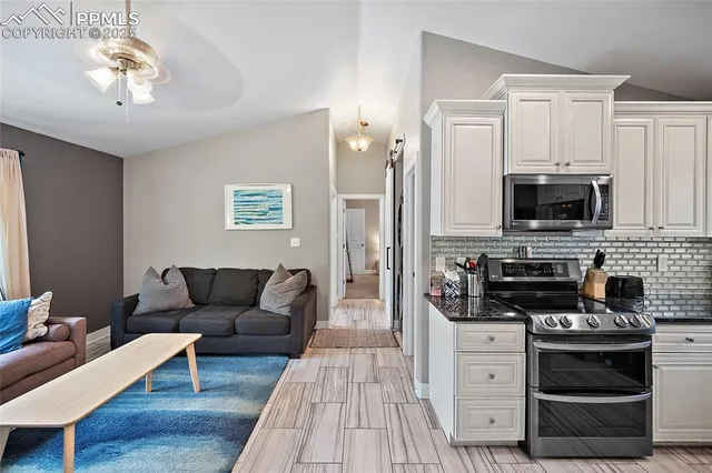 a living room with furniture a fireplace and a flat screen tv