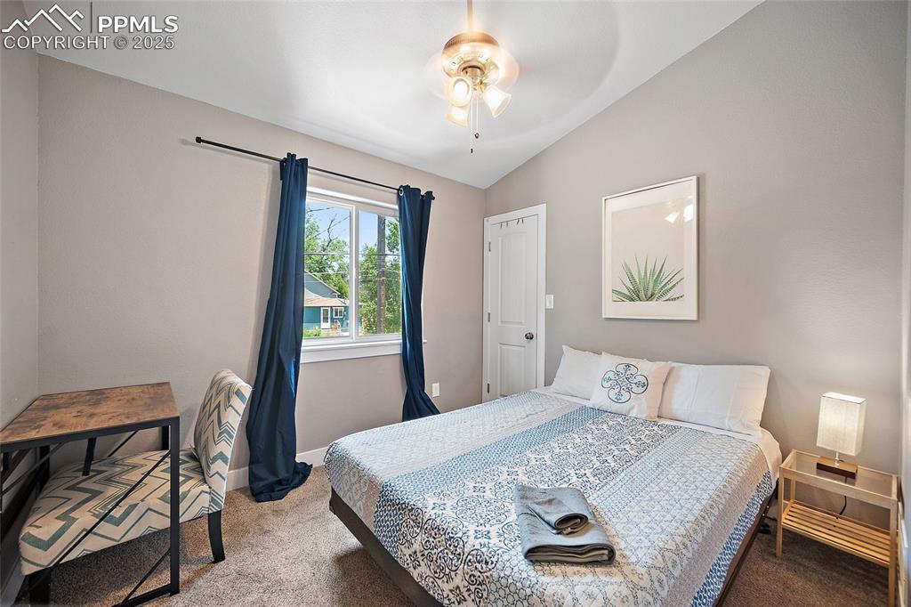 225 Custer Avenue Colorado Springs, CO 80903 - Photo 27 of 39 a bedroom with a bed and a chair with the potted plant