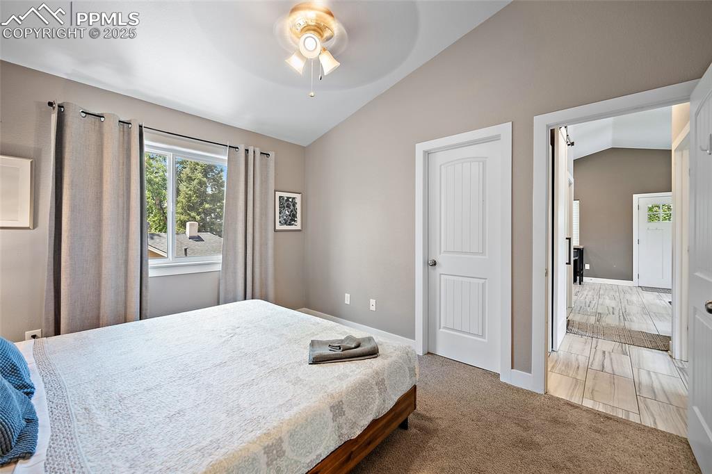 225 Custer Avenue Colorado Springs, CO 80903 - Photo 31 of 39 a bedroom with a bed and a chandelier