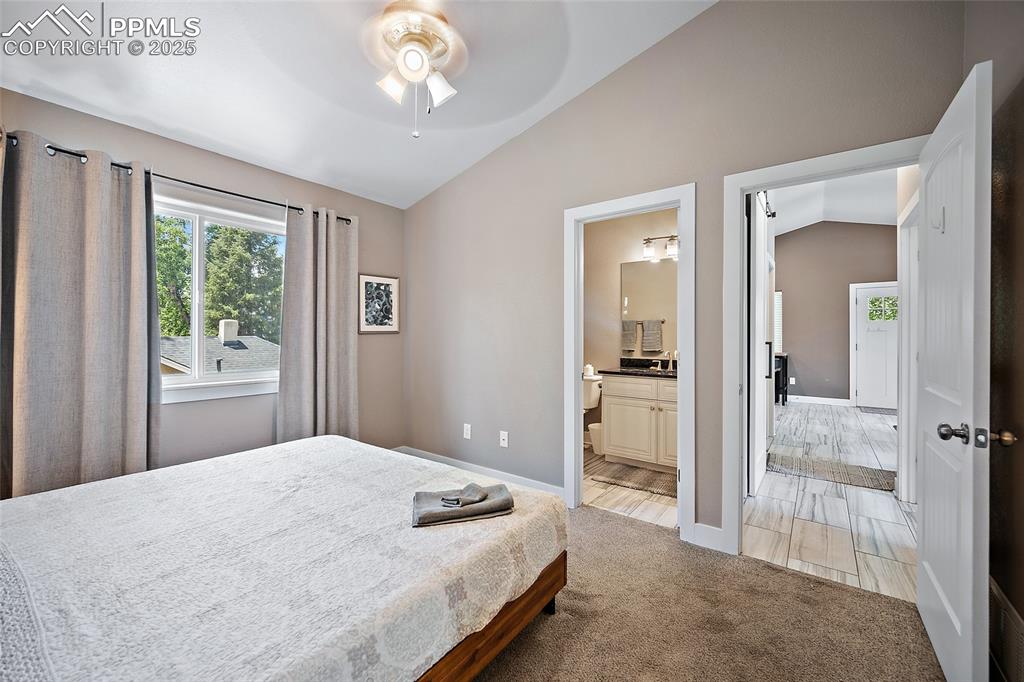 225 Custer Avenue Colorado Springs, CO 80903 - Photo 32 of 39 a bedroom with a large bed and a chandelier