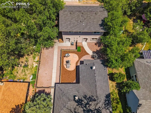 an aerial view of a house with garden space and street view