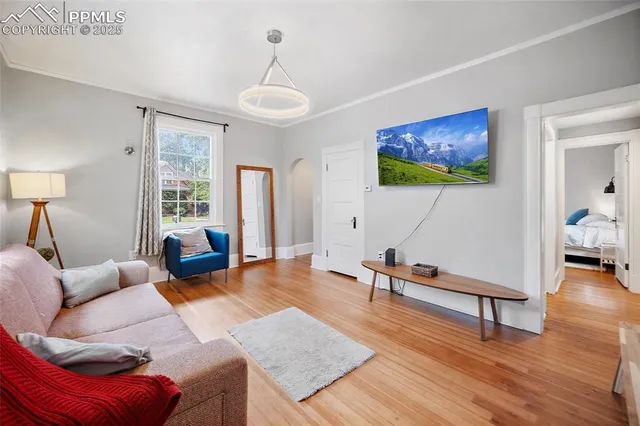 a living room with furniture and a wooden floor