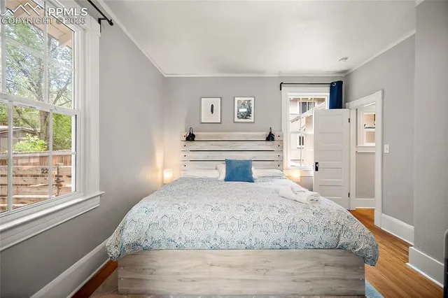 a bedroom with a large bed and a window