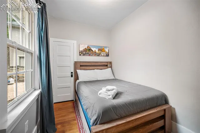 a bedroom with a bed and a window with outer view