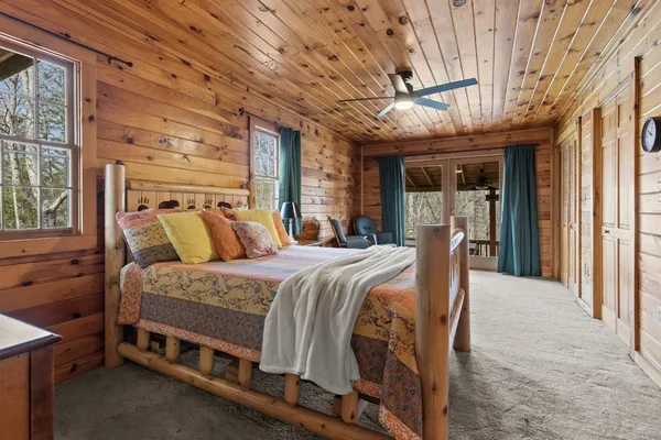 a bed sitting in a spacious bedroom next to a window