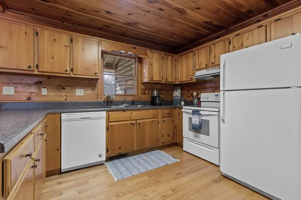 a kitchen with cabinets stainless steel appliances and sink