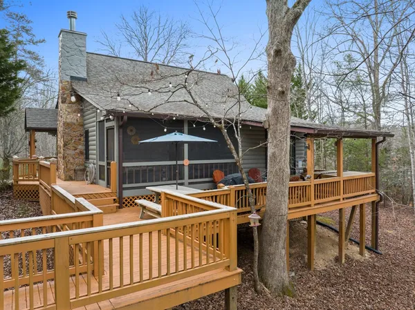 a view of a roof deck with table and chairs