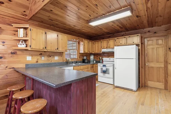 a kitchen with refrigerator and cabinets