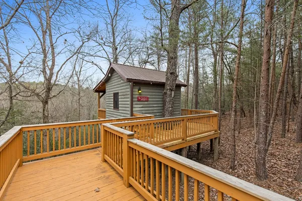 a view of a house with a wooden deck