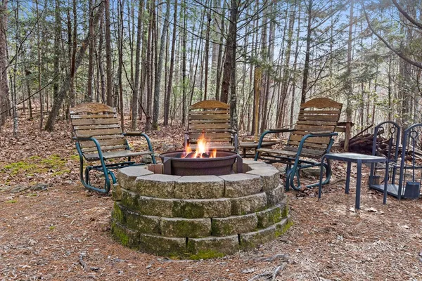 a view of a chairs and table in backyard