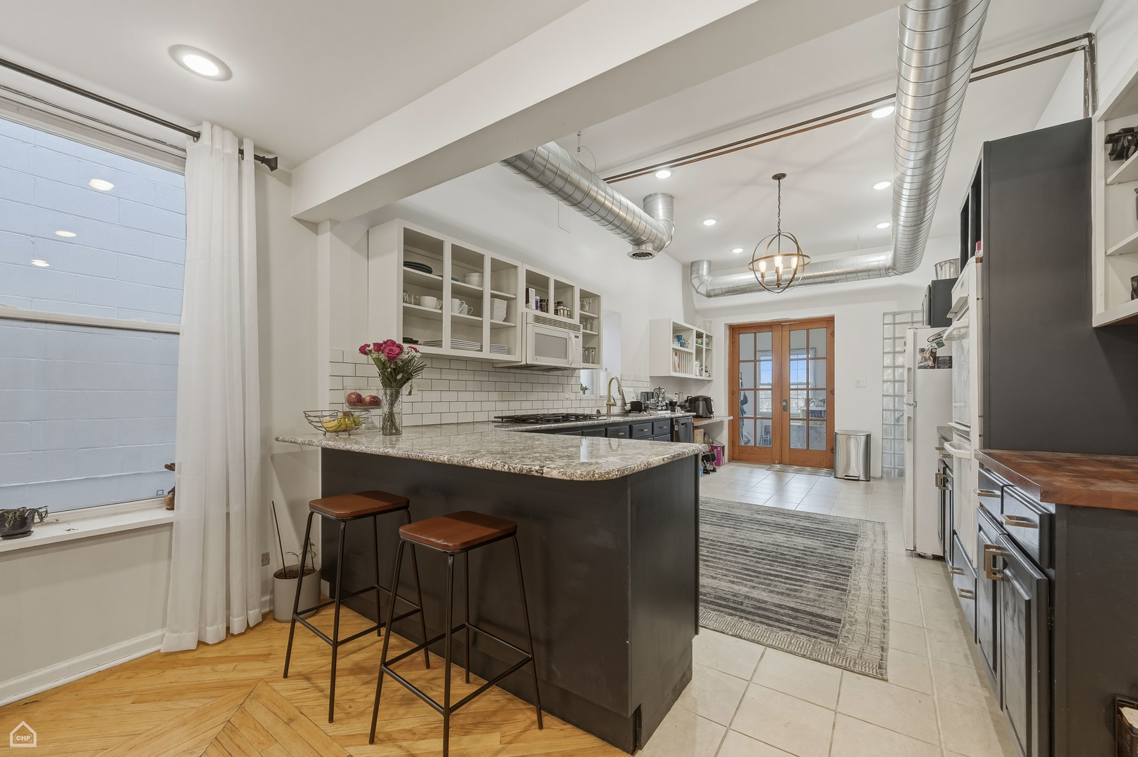 822 North Wood Street Chicago, IL 60622 - Photo 6 of 28 a kitchen with granite countertop a sink and a refrigerator