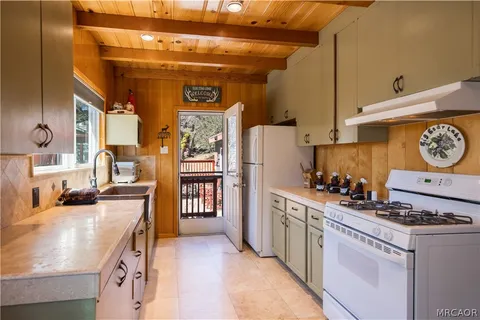 a kitchen with stainless steel appliances granite countertop a stove and a refrigerator