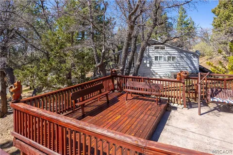 a view of outdoor space with deck and trees