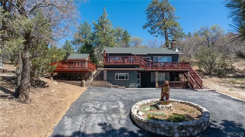 a house view with a sitting space fire pit and outdoor space