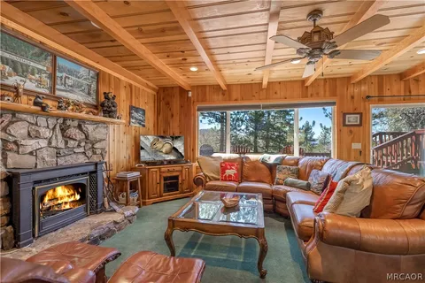a living room with furniture a fireplace and a table