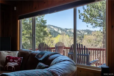 a living room with couch and a floor to ceiling window