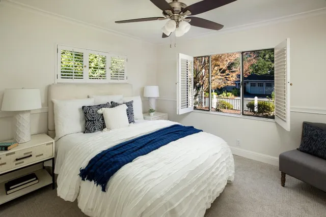 a bedroom with a balcony a bed and a couch