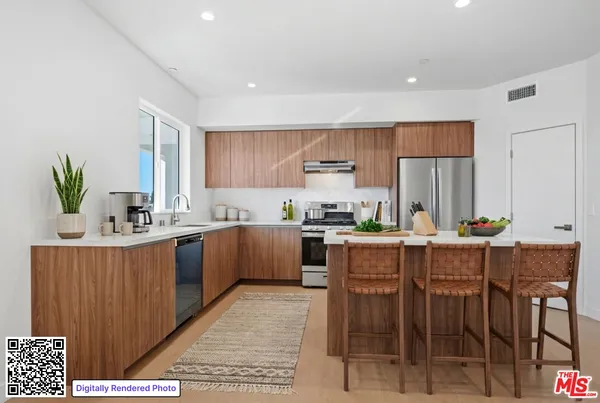 a kitchen with a table chairs microwave and cabinets