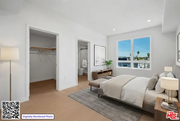 a bedroom with a bed and a night stand