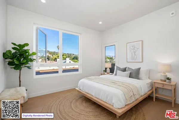 a bedroom with a bed potted plant and a window