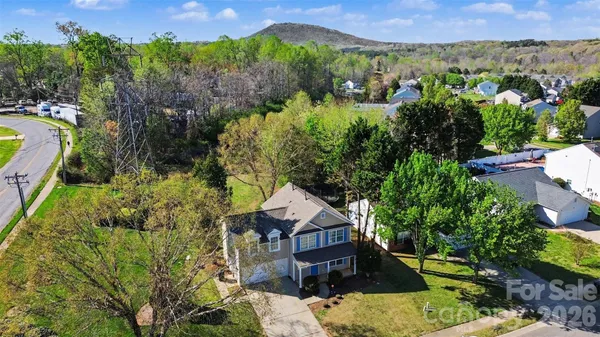 an aerial view of a house with a yard