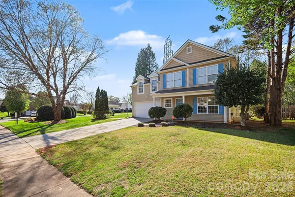 a view of a house with a yard patio and fire pit